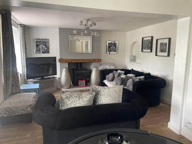 A living room with a sofa and television at Immaculate 3Bed House in Bridgnorth