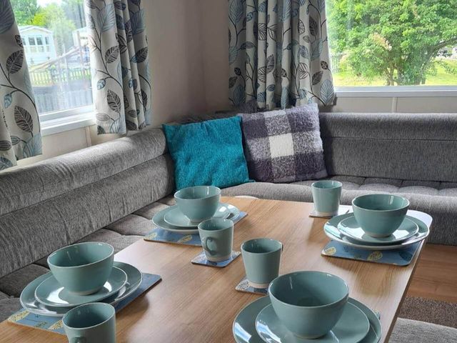A dining area with plates and cups on a table at The Old Barn in Manchester