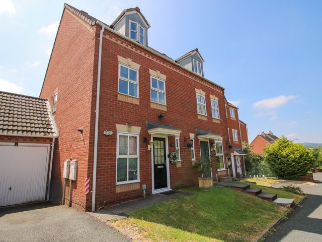 An exterior view of a house with a garage and garden at 18 Hengrave Meadow in Telford