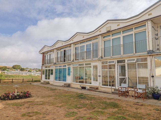 An exterior view of a building with balconies and outdoor furniture at 4 Kingfisher Court in West Bay