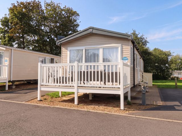 A mobile home with deck and steps at Marton Mere Westminster in Blackpool