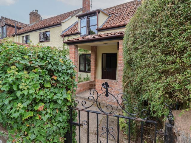 A house with a brick entrance and a black gate at The Cottage in Bridgwater