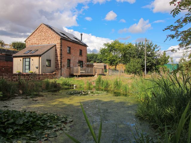 A house with a deck near a pond at The Old Mill Great Bolas near Telford