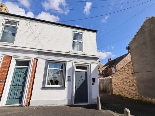 An exterior view of a house on a street at The Old Bank House Red Row near Amble
