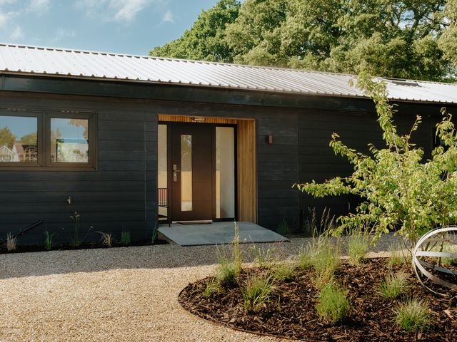 An outdoor area with gravel path and front door at Baldslow Barn in Battle near Hastings