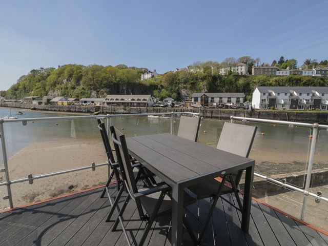 A table and chairs near the water at Seafarer's Haven in Porthmadog