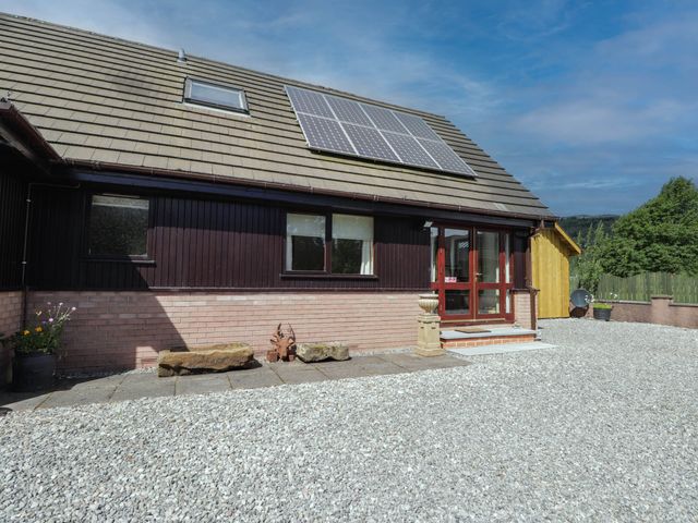 An outdoor view of a house with solar panels at Park House Cannich Holiday Retreat in Cannich