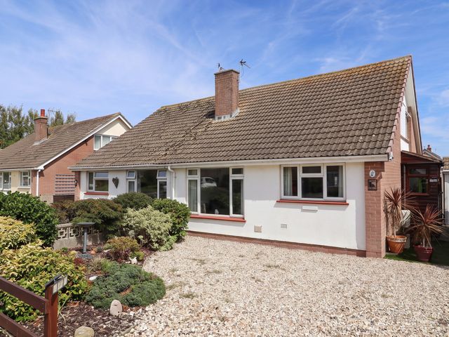 A house with windows and a gravel driveway at 56 Steart Gardens Burnham-on-Sea