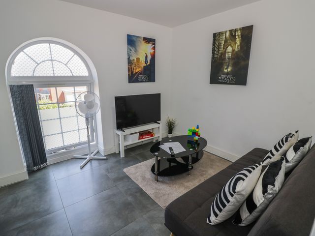 A living room with a television and a coffee table at 3 Pump House in Birmingham