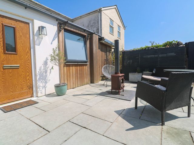 An outdoor area with a wooden door and seating at The Lookout in Redruth