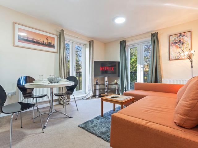A living room with a television and dining table at Flat 34 Herbert James Close in Birmingham