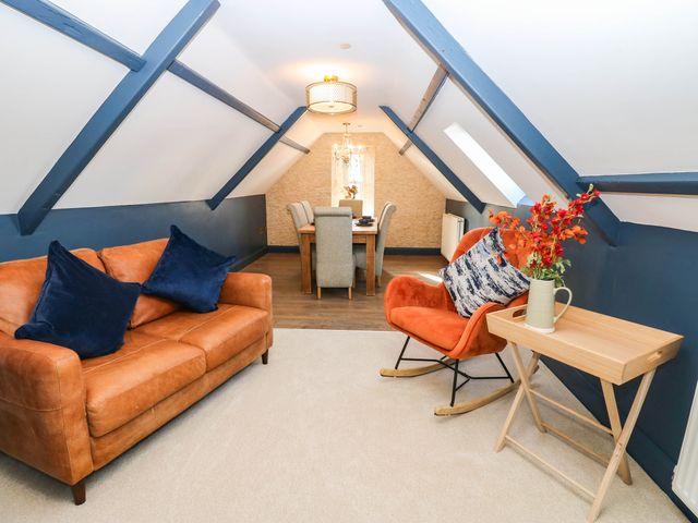 A living room with a sofa and dining area at Bishops Quarter - Flambard, Bishop Auckland