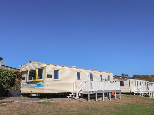 A mobile home with a deck and steps at Beech Walk 3 in Sandy Bay, Exmouth