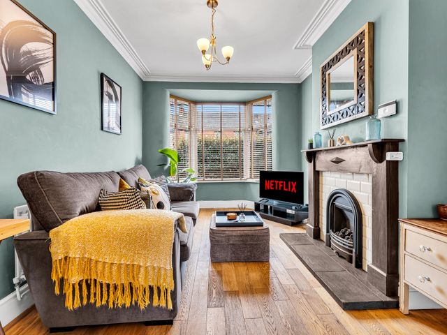 A living room with a sofa and television at Stoke Townhouse in Stoke-on-Trent