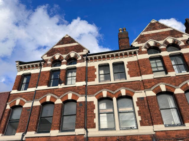 A building exterior with windows and detailed brickwork at The Jewel Box Birmingham City Apartment Birmingham