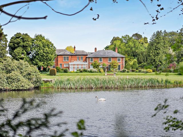 A house with a pond in the garden at Staunton Park Leominster
