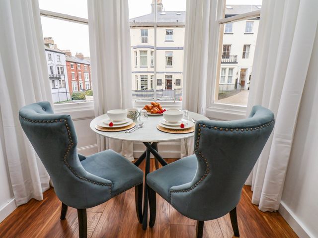 A dining room with a table set for breakfast at Flat 1 in Whitby