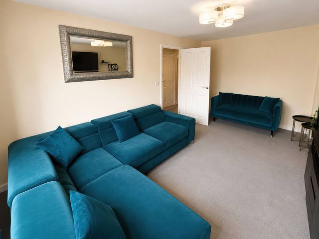 A living room with a sofa and TV at 4 Britannia Street in Salford