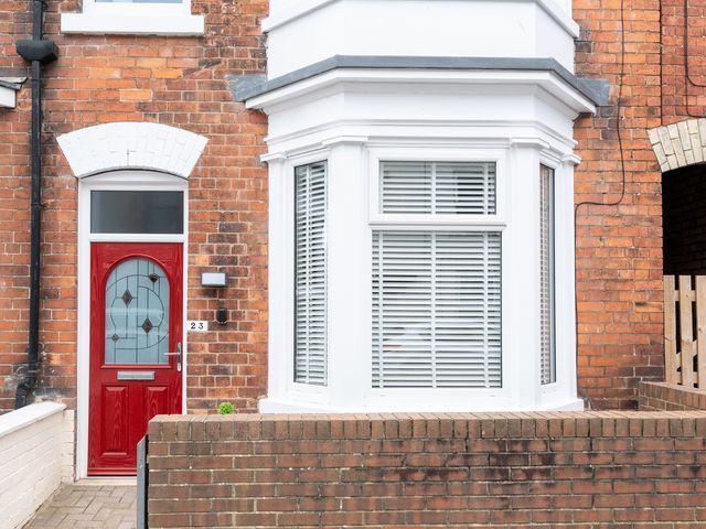 A house exterior with a red door and bay window at 23 Trafalgar Road in Scarborough