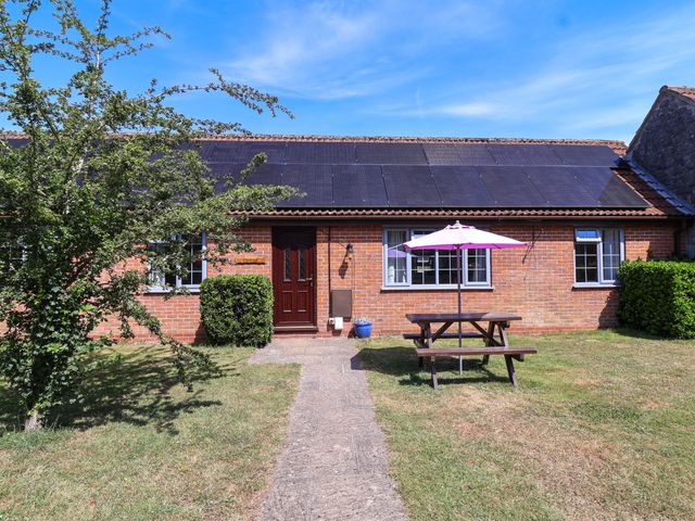 An exterior view of a house with a picnic table and solar panels at Chestnut in Weston-super-Mare