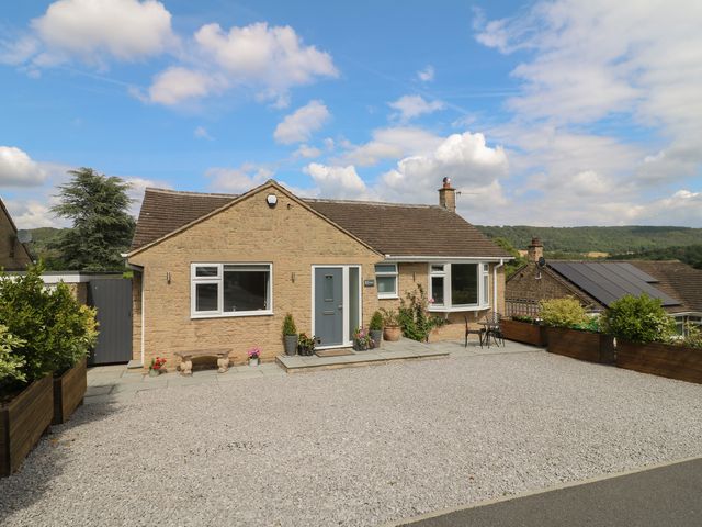 A house with a gravel driveway and plants at Hillset View in Bakewell