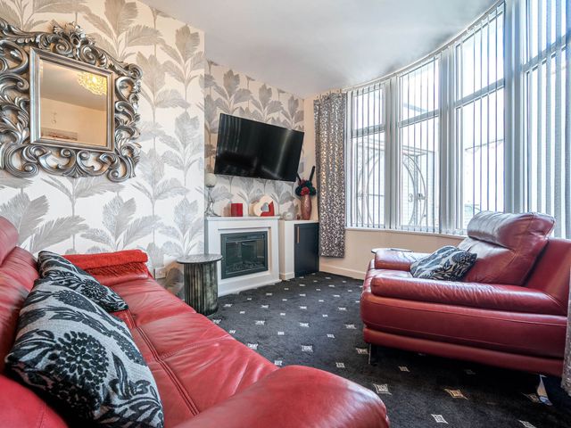 A living room with a television and a fireplace at Ground Floor 1Bed Apartment at SeaCote in Bispham