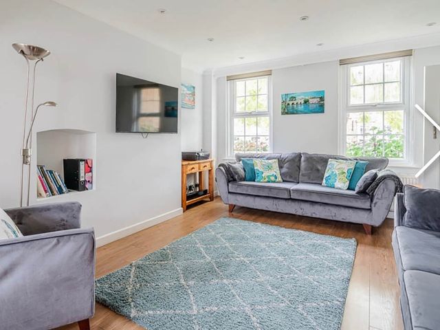 A living room with a sofa and television at 3 bedroom house 3mins to beach PetsOk, Milford On Sea