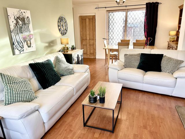 A living room with sofas and a dining area at 6 Guests 3Bed House in Chester le Street