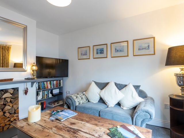 A living room with a sofa and TV at Cozy Nook boutique Cottage in Oakham