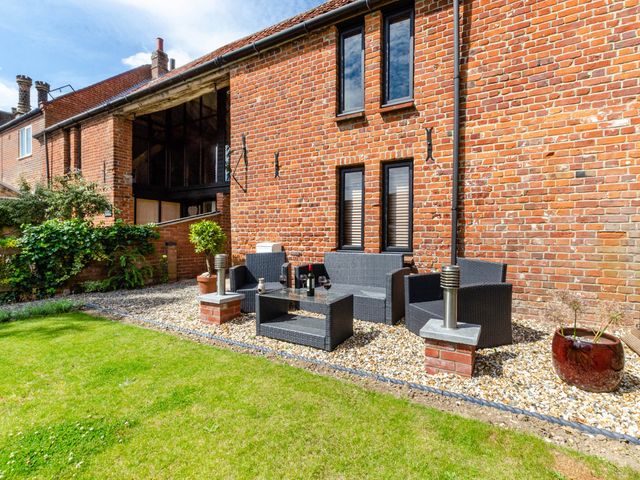 Outdoor seating area with a garden at 1880s Barn Conversion Sleeps4 Pet Friendly Hereford