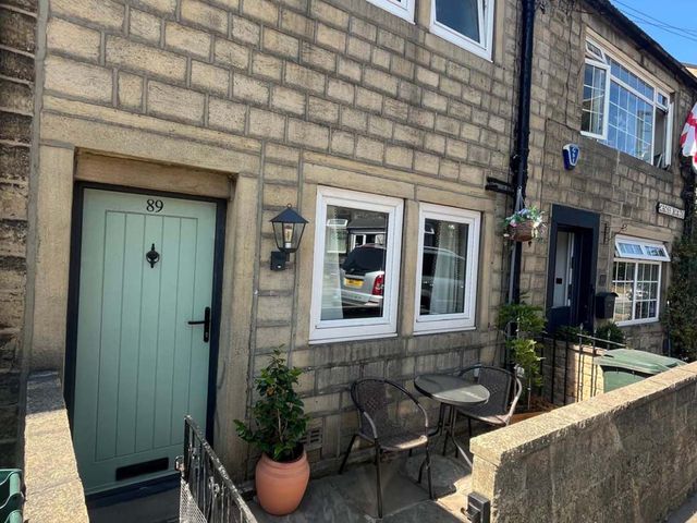 An outdoor area with a door and seating at Cozy Cottage Retreat near Haworth log burner, Keighley