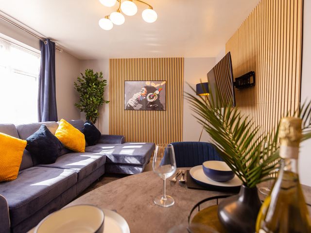 A living room with a sofa and television at the property