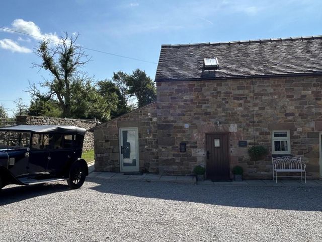 An outdoor view of a stone building with a car parked in front at Barn Sleeps 4 Parking Near Alton Towers Waterhouses