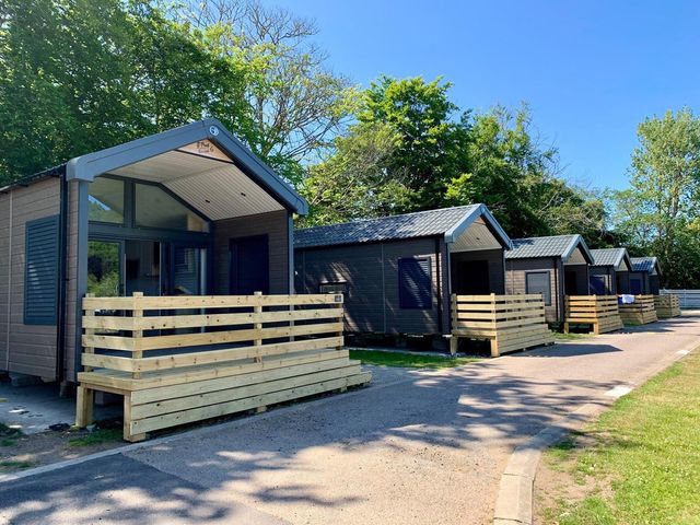 A row of cabins with wooden decking and a pathway at Selfcatering Lodge Inverness Sleeps 4 Inverness