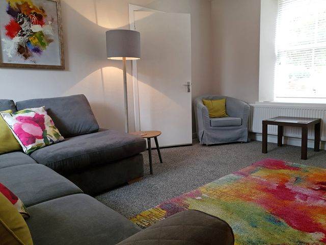 A living room with a sofa and lamp at the property