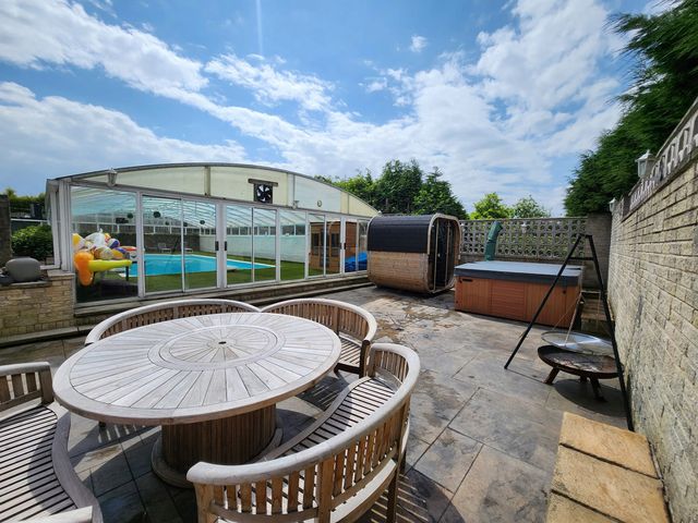 An outdoor area with a table, chairs, hot tub and sauna at RentMySpaHome with Swimming Pool Hot Tub and Sauna Aughton