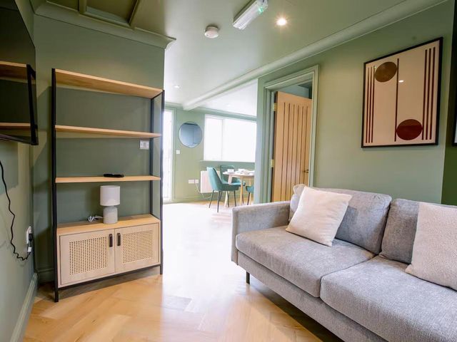 A living room with a sofa and shelf at 1 Bedroom Apartment Sleeps 2 Pets Welcome in Carbis Bay