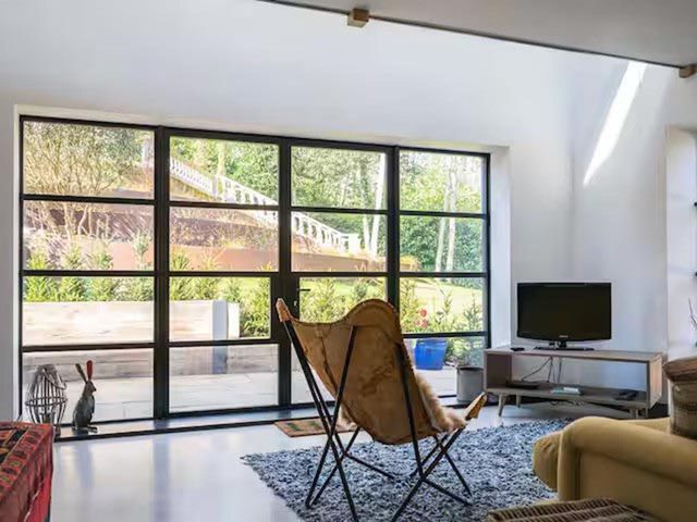 A living room with a window and a television at the property