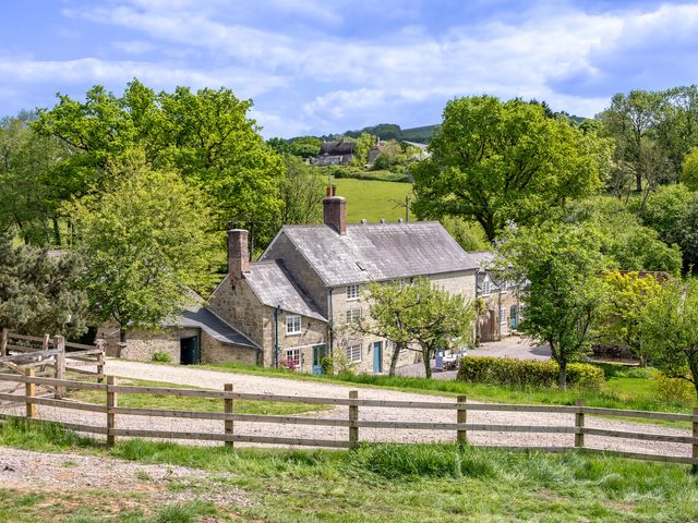 An outdoor view of a house surrounded by trees at French Mill in Shaftesbury
