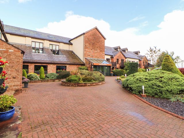 An outdoor view of a building with a pathway and landscaped gardens at Ullswater Apartment- No 15