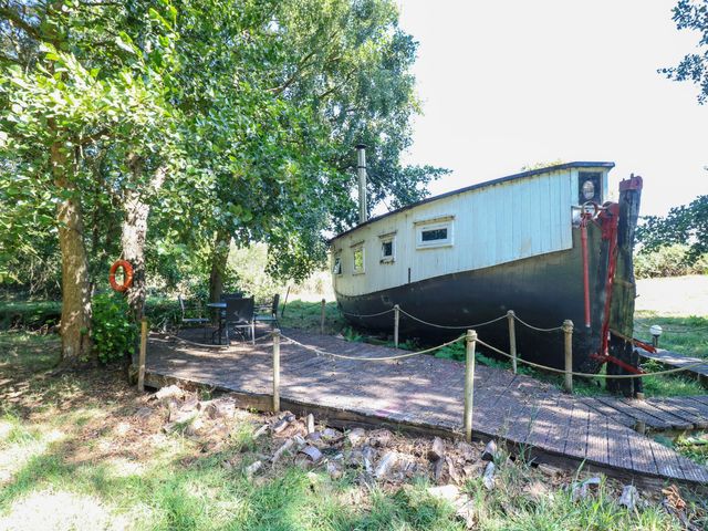 An exterior view of a boat with a deck and seating area at Ladies of Bolton in Horsford