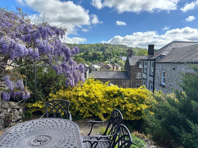 A garden view with wisteria and a table at The Brew House in Bakewell