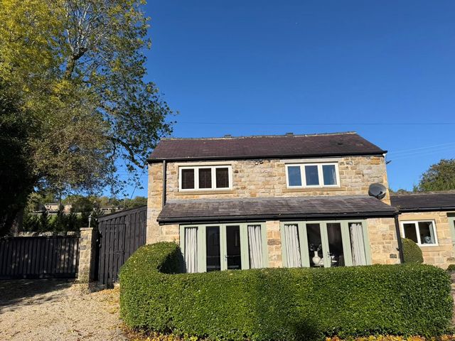 A house with trees and a gate at Honey Pot Cottage near Harrogate