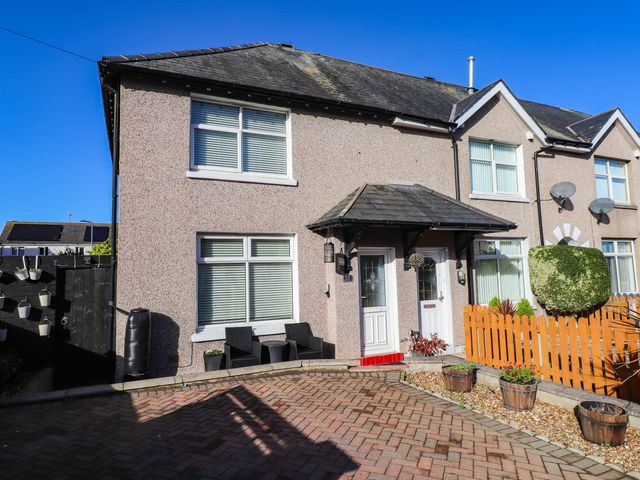 A house with a garden and chairs at Carol Ann Llandudno
