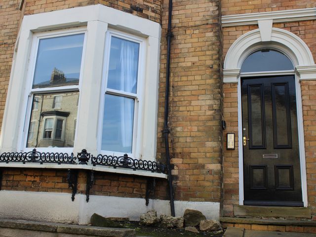 A door and window on a brick wall at Oliver Wests Apartment 1 Scarborough