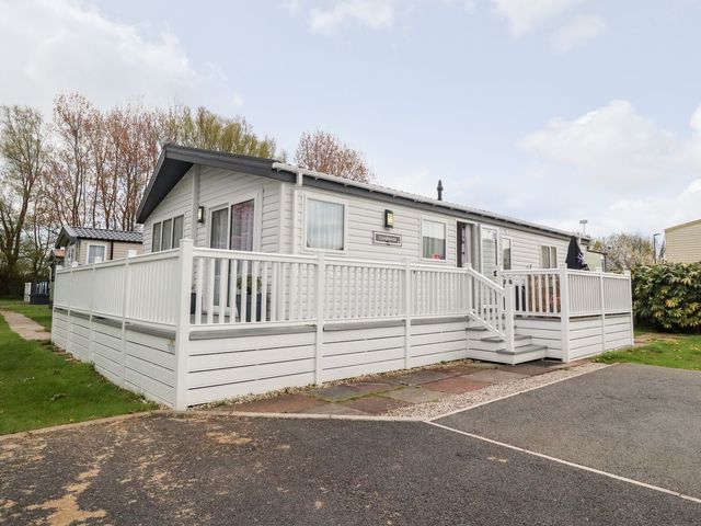 A house with a deck and steps at Rosella 38 Morecambe