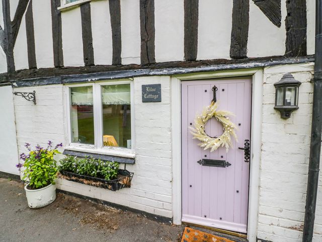An exterior view of a doorway with a wreath at Lilac Cottage in Brinklow