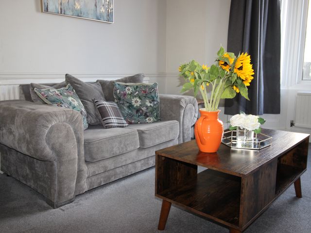 A living room with a sofa and a coffee table at The Hampton in Scarborough