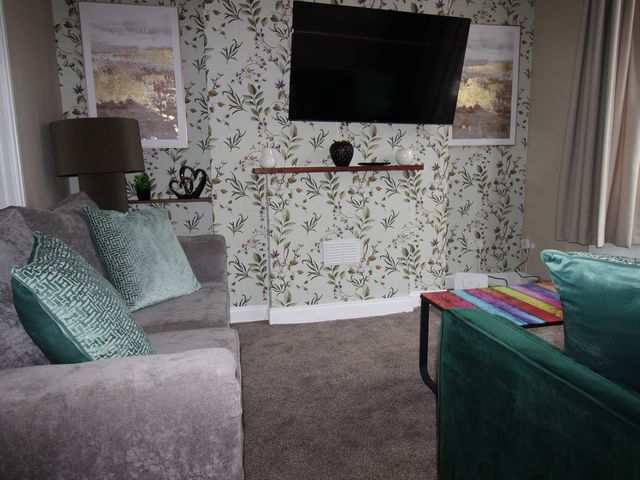 A living room with a couch and television at Brinkburn House Scarborough