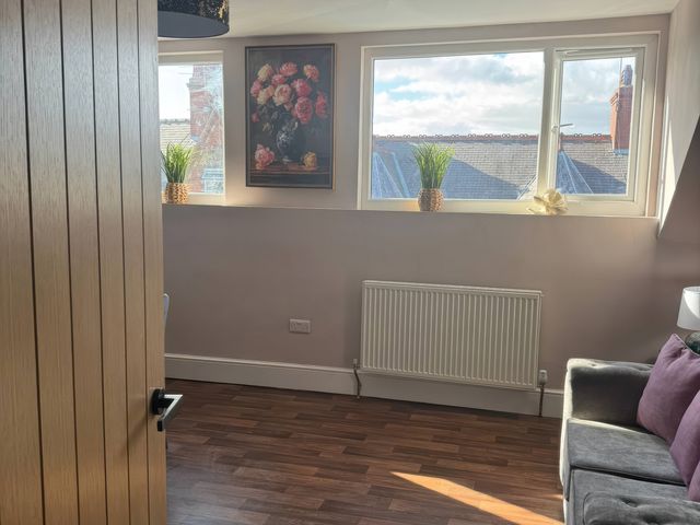 A snug with a window and radiator at Blackburn Heights Apartment 3 in Bridlington